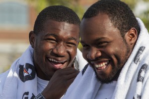 Linebacker Chris Norman, left, and nosetackle Anthony Rashad White laugh during player introductions.